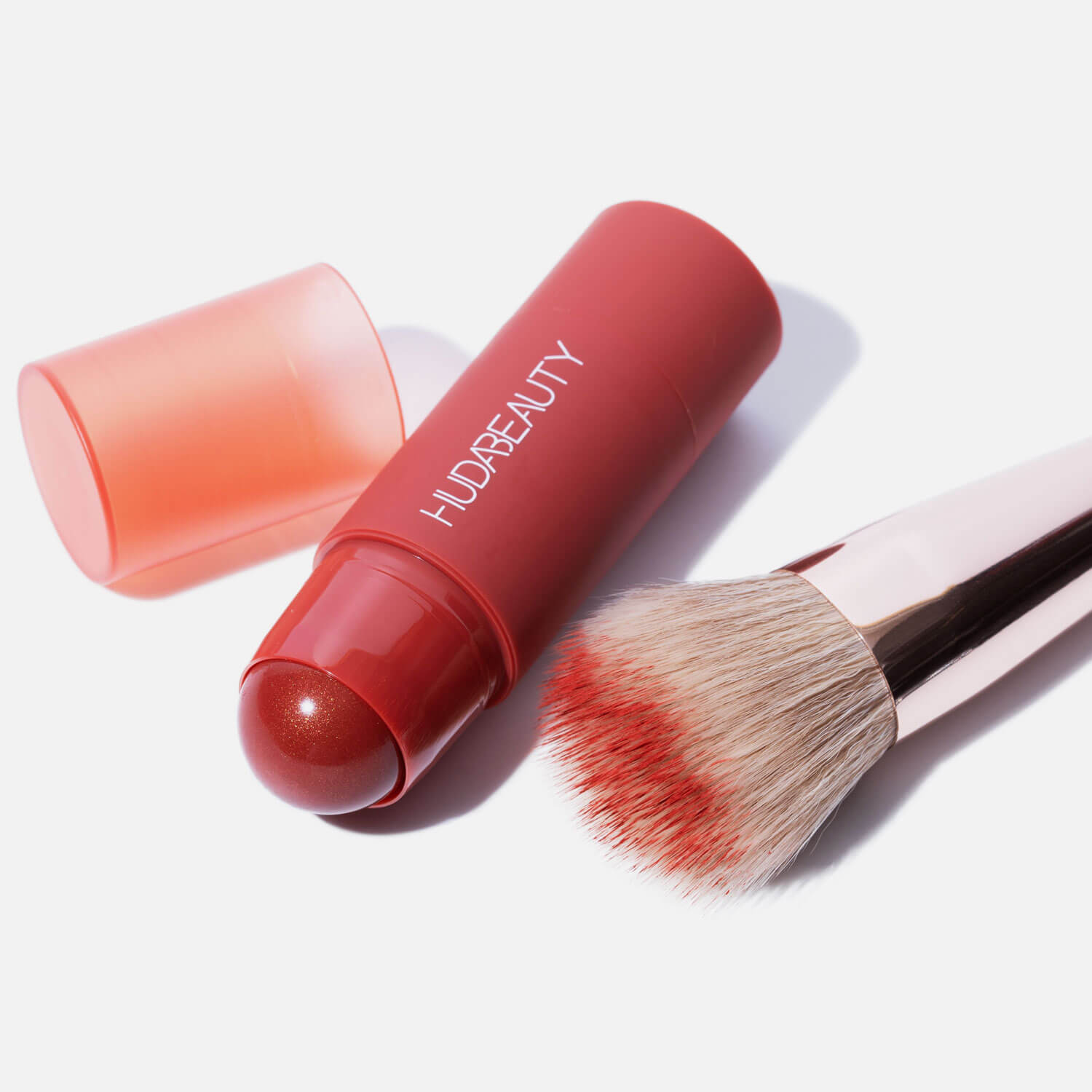 Model applying cheeky blush stick.